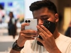 A customer uses Apple's new foldable iPhone Duo at the Apple store in Mumbai, India, October 23, 2026.