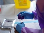 A health worker collects a blood sample from a patient before administering a dose of the Tumaini vaccine against Ebola virus, in Ituri, Congo.