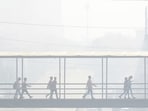 Gurugram: Commuters use a foot overbridge amid smog, in Gurugram. (PTI)