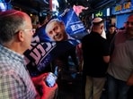 A supporter of Israeli Prime Minister Benjamin Netanyahu, leader of the Likud party, displays a flag depicting him at Mahane Yehuda market, ahead of Israel's national election, in Jerusalem. 