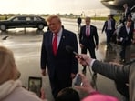 President Donald Trump talks to reporters after arriving on Air Force One at President Donald J. Trump International Airport in West Palm Beach, Florida.