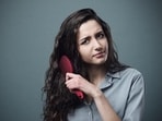 Pony tails are the best way to sort frizzy hair. (Adobe Stock)