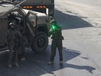 An Israeli soldier aims is weapon as Israeli security forces patrol the area where the houses of the two Palestinian gunmen, who killed two Israeli soldiers and injured three others earlier in the day, are located, in the Israeli-occupied West Bank city of Hebron on October 23, 2026. (AFP)