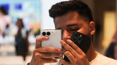 A customer uses Apple's new foldable iPhone Duo at the Apple store in Mumbai, India, October 23, 2026. (REUTERS)