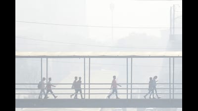 Gurugram: Commuters use a foot overbridge amid smog, in Gurugram. (PTI) Gurugram: Commuters use a foot overbridge amid smog, in Gurugram. (PTI)