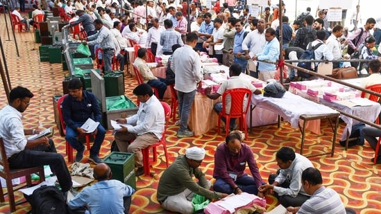 Polling officials collect election materials as they leave for their designated polling stations on the eve of elections for Uttar Pradesh Legislative Council (MLC) Graduate and Teacher constituencies, in Prayagraj on Thursday.