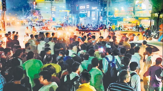 Locals blocked the railway station road on Friday to protest against the prolonged power cut. (HT Photo)
