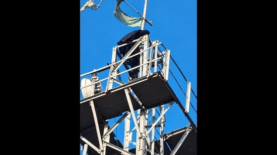 Woman atop mobile tower in Bahraich (HT PHOTO)