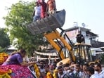 A bulldozer being used to shower petals on UPCC president Aradhana Mishra in Pratapgarh on Saturday. (Sourced)