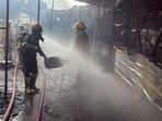 Firefighters carried out dousing operations after a major fire broke out at temporary food shops in Raipur village, Noida, on Saturday.