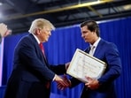 Joe Mitchell presented Trump with a self-created “Man of the Century Award” at an Iowa rally.(REUTERS)