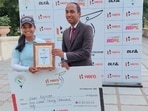 Vani Kapoor receiving the winner's cheque and trophy from Mr Sunil Chandran, DGM-DLF G&CC.