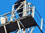 Woman atop mobile tower in Bahraich (HT PHOTO)