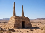 Representative image of an ancient stone tomb in the desert, featuring two towering stone pillars and a mysterious structure dating back thousands of years.