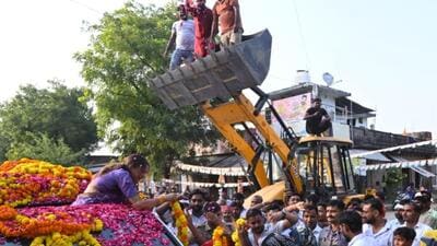 A bulldozer being used to shower petals on UPCC president Aradhana Mishra in Pratapgarh on Saturday. (Sourced)