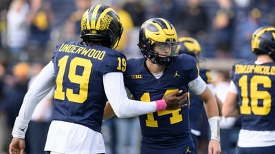 Michigan quarterback's Bryce Underwood (19) and Tommy Carr (14) exchange pleasantries during pregame warmups before their NCAA college football game against Indiana in Ann Arbor, Michigan. (AP Photo/Lon Horwedel) Michigan quarterback's Bryce Underwood (19) and Tommy Carr (14) exchange pleasantries during pregame warmups before their NCAA college football game against Indiana in Ann Arbor, Michigan. (AP Photo/Lon Horwedel)