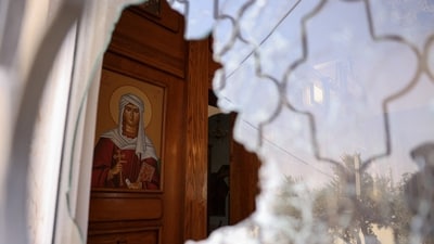 A shattered window at Saint George’s Greek Orthodox Church, where gunmen opened fire during a funeral the previous day, in the village of Hamoud, Karak, Jordan. (REUTERS)