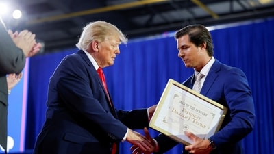 Joe Mitchell presented Trump with a self-created “Man of the Century Award” at an Iowa rally. (REUTERS)