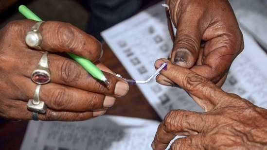 Voters queue outside a polling booth as voting begins for panch and sarpanch posts in 3,314 gram panchayats across Rajasthan.