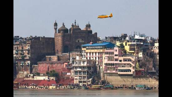 A vintage North American T-6 Texan, an Indian Air Force (IAF) Heritage Flight aircraft, flies past the Alamgir Mosque during the 'Wings Over Ganges' air show over the river Ganges in Varanasi on October 24 (AFP)