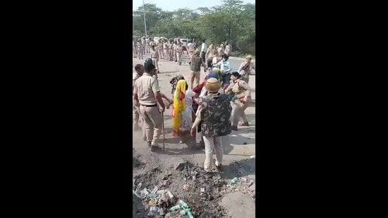 Cops seen removing protesters from the site. (HT)
