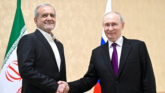 Russian President Vladimir Putin shakes hands with Iranian President Masoud Pezeshkian during a meeting in Turkmenbashi, Turkmenistan.
