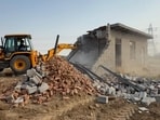 During the drive, enforcement teams demolished boundary walls, plinth-level structures, private offices, sewer lines and earthen road networks across these unauthorised colonies. (HT) During the drive, enforcement teams demolished boundary walls, plinth-level structures, private offices, sewer lines and earthen road networks across these unauthorised colonies. (HT)