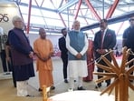 Prime Minister Narendra Modi and Uttar Pradesh chief minister Yogi Adityanath during the inauguration of a garment manufacturing plant in Varanasi on Sunday. (PTI PHOTO)