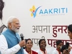 Prime Minister Narendra Modi during an interaction with women workers in Varanasi on Sunday. (PTI PHOTO)