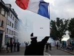 A protester holds a French flag during a demonstration against rising living costs in Strasbourg, France, Saturday, Oct. 24, 2026.