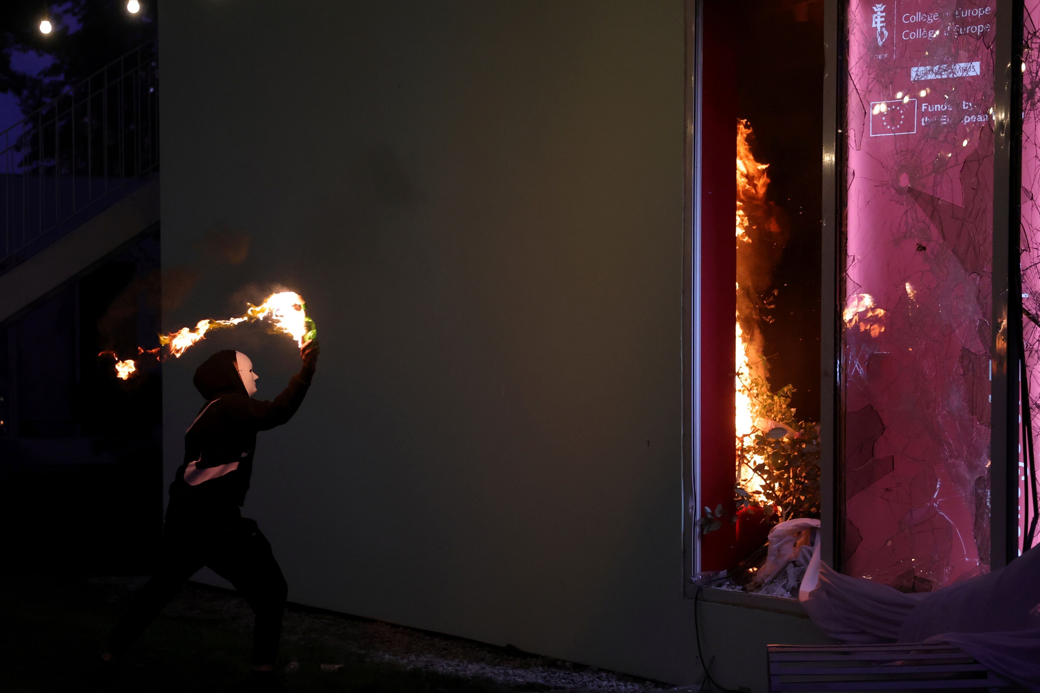 A hooded protester throws a petrol bomb at the College of Europe office during clashes in Tirana, Albania. (AP Photo/Hameraldi Agolli) A hooded protester throws a petrol bomb at the College of Europe office during clashes in Tirana, Albania. (AP Photo/Hameraldi Agolli)