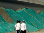  The green nets placed over the soil mounds at Haji Ali area mandated dust-mitigation and air pollution control measure and infrastructure excavation sites across Mumbai area,(HT Photos )