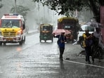 Pedestrians holding umbrellas amid heavy rainfall triggered by Cyclone Arnab in Patna on Saturday. 