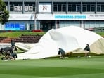 Ground staff struggle with the covers amid very strong winds during a training session at the Basin Reserve in Wellington.