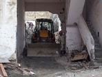 An excavator at the site as a rescue operation is underway after a slab of a house under construction collapsed in Harsh Vihar, northeast Delhi, on Monday, Oct. 26, 2026.