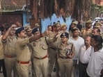 Police personnel inspect the site where three people were killed in a firing incident following a clash over a parking spot in Lucknow on Monday (PTI)