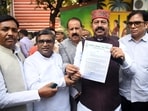 RJD MLAs Bhai Birendra, Ranvijay Sahu and others show a letter after meeting the Chief Electoral Officer in Patna on Monday. (Santosh Kumar/HT)