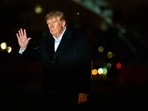 President Donald Trump waves to reporters as he walks across the South Lawn of the White House after stepping off Marine One, Sunday. 