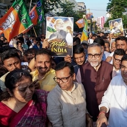 BJP leader Tapas Roy, centre, along with party leaders and workers during a protest against Congress President Mallikarjun Kharge over his alleged derogatory remarks against PM Modi, in Kolkata, Monday, Oct. 26, 2026. 