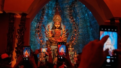 People take photos of an idol of Hindu goddess Durga at a makeshift worship venue on the last day of the festival Durga Puja. (AP Photo/file)