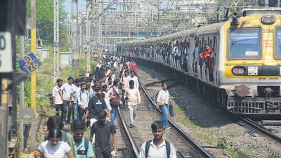 As crowds swelled on platforms and inside trains, several frustrated commuters got down and walked along the tracks to reach nearby stations. (Praful Gangurde / Hindustan Times) As crowds swelled on platforms and inside trains, several frustrated commuters got down and walked along the tracks to reach nearby stations. (Praful Gangurde / Hindustan Times)