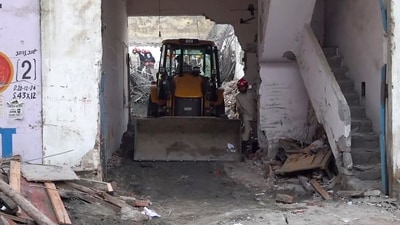An excavator at the site as a rescue operation is underway after a slab of a house under construction collapsed in Harsh Vihar, northeast Delhi, on Monday, Oct. 26, 2026. (PTI) An excavator at the site as a rescue operation is underway after a slab of a house under construction collapsed in Harsh Vihar, northeast Delhi, on Monday, Oct. 26, 2026. (PTI)