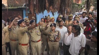 Police personnel inspect the site where three people were killed in a firing incident following a clash over a parking spot in Lucknow on Monday (PTI) Police personnel inspect the site where three people were killed in a firing incident following a clash over a parking spot in Lucknow on Monday (PTI)