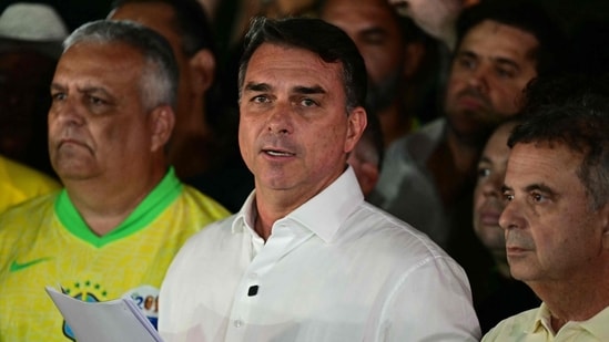 Flavio Bolsonaro reacts after knowing the first results in the presidential runoff election, in Brasilia. (AFP)
