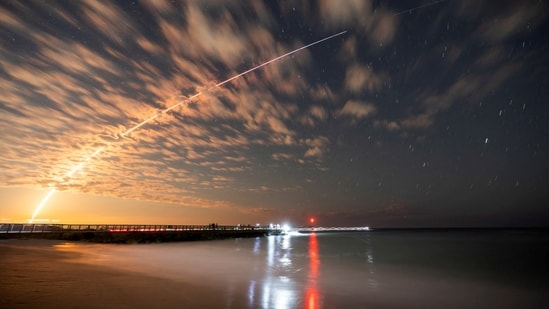 FILE PHOTO: The SpaceX Falcon 9 rocket carrying Starlink satellites is seen over Sebastian Inlet after launching from Cape Canaveral, Florida, U.S., February 26, 2025.