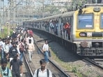 As crowds swelled on platforms and inside trains, several frustrated commuters got down and walked along the tracks to reach nearby stations. (Praful Gangurde / Hindustan Times)