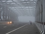 Villagers walk in the morning fog through an overhead bridge of a newly constructed national highway near Baghpat, India, Tuesday, Sept. 29, 2026.(AP Photo/Rajesh Kumar Singh)