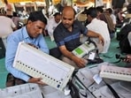 Election staff check electronic voting machines (EVM) at a distribution centre.