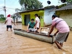 People use a boat to move through a waterlogged area as they leave a flooded low-lying settlement along NH-30 at Donga Ghat following heavy rain caused by Cyclonic Storm Arnab and the release of water from Khatiguda Dam in Odisha, at Jagdalpur, in Bastar district, Chhattisgarh, Sept. 26, 2026. (PTI)