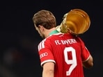 Bayern Munich's Harry Kane carries the trophy as he celebrates winning the DFB Cup 